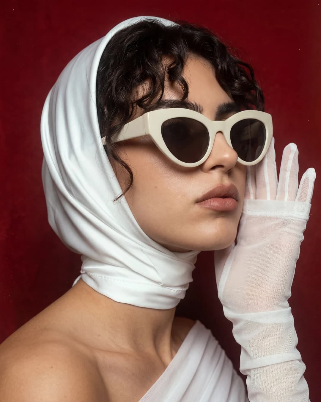 Woman in white head scarf with cream cat-eye sunglasses — AI eyewear photography for ecommerce