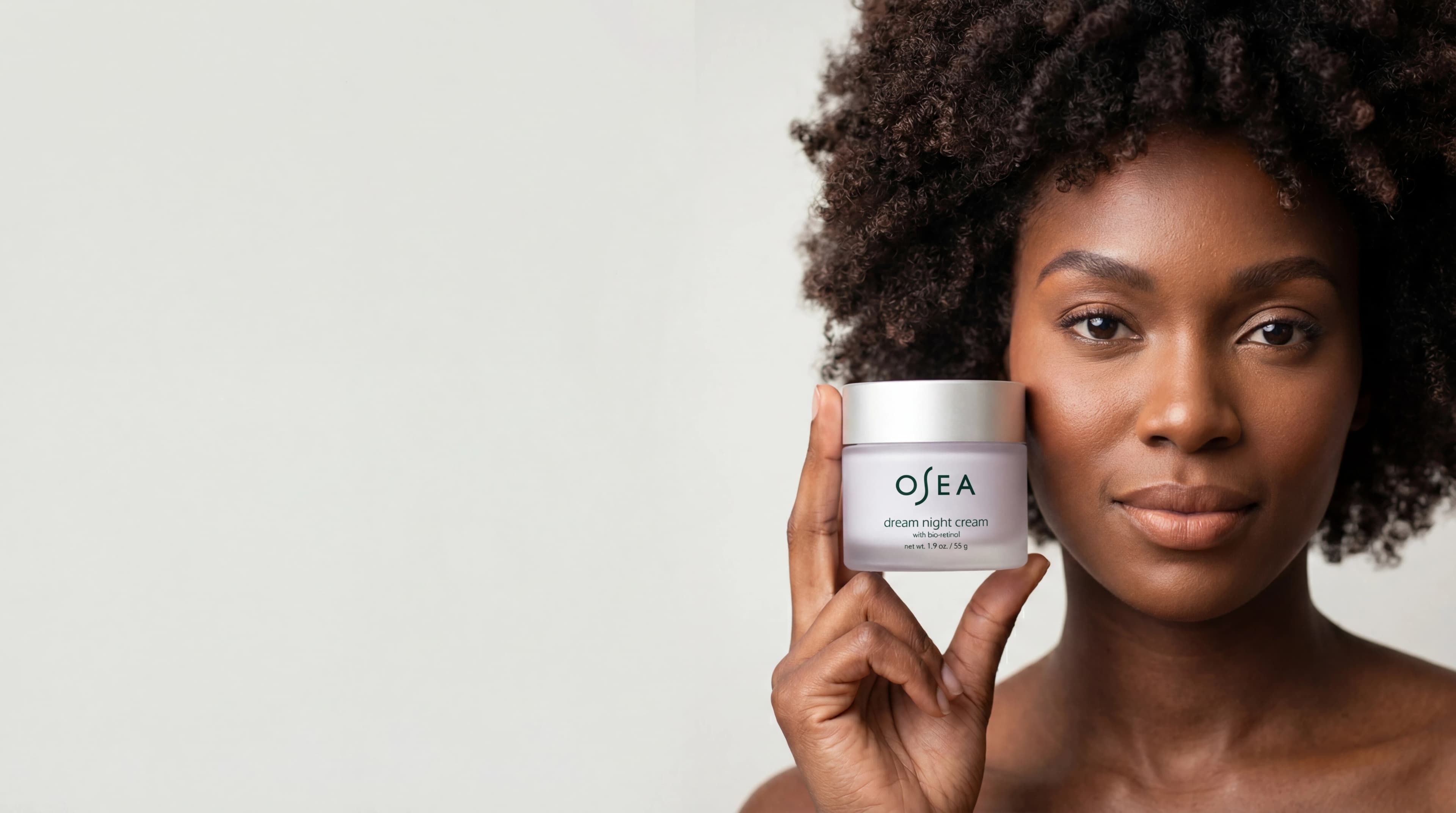 Woman holding skincare cream jar near face — AI skincare product photography for D2C beauty brands