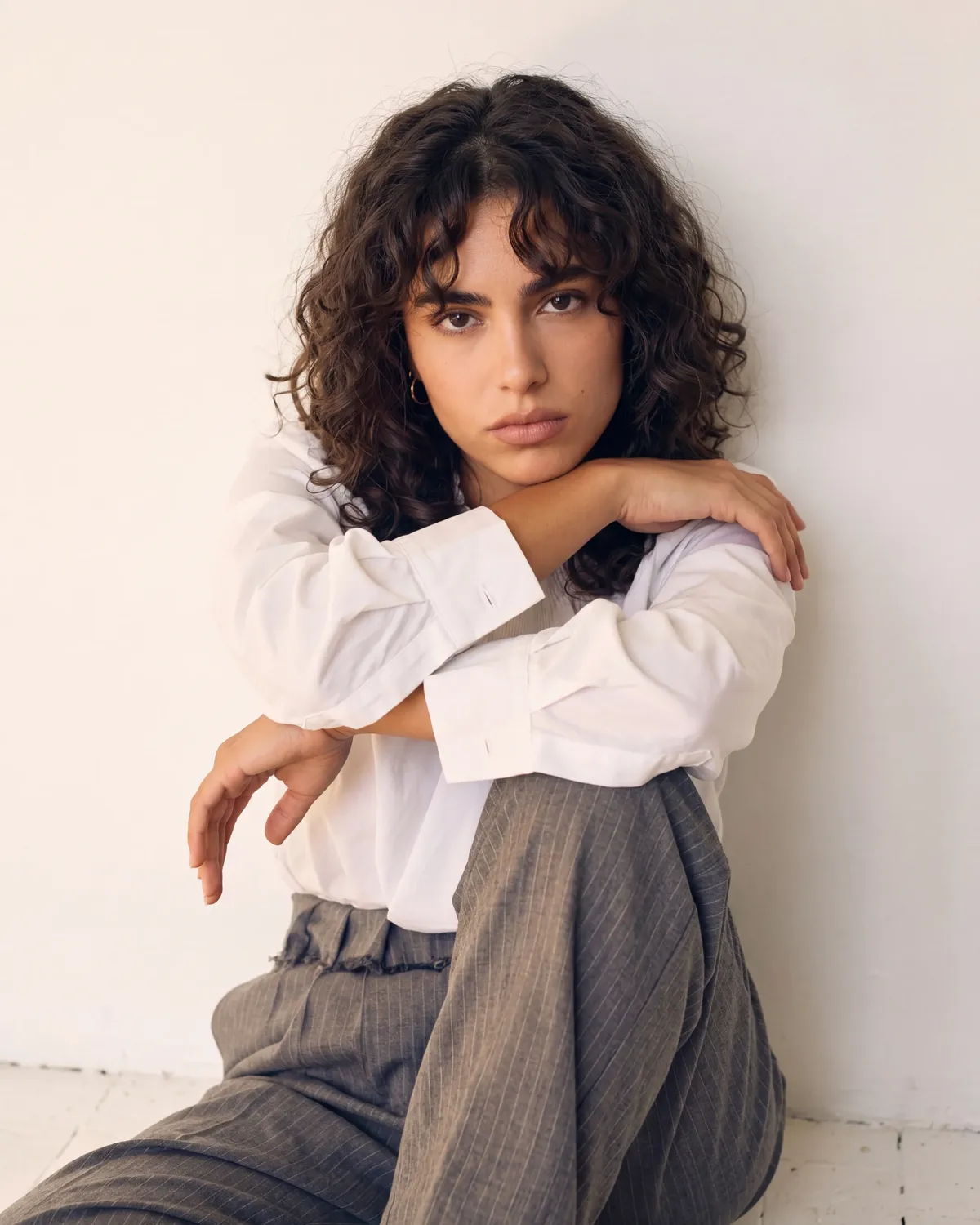 Woman in white shirt and grey pinstripe trousers — AI apparel photography for ecommerce brands