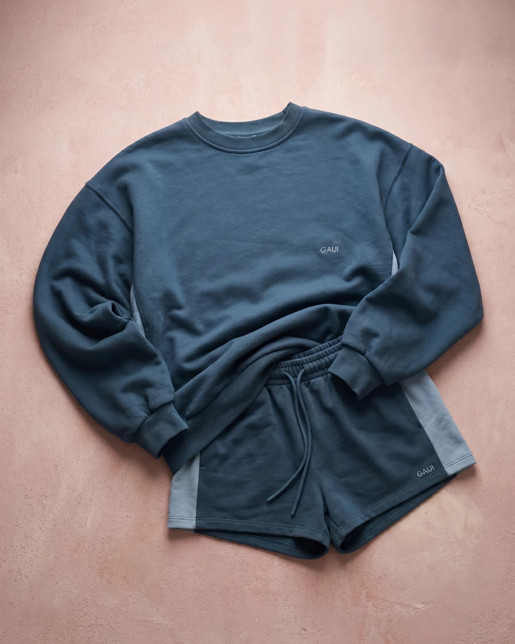 Flat-lay of navy sweatshirt and shorts set — AI apparel product photography for ecommerce flat-lays