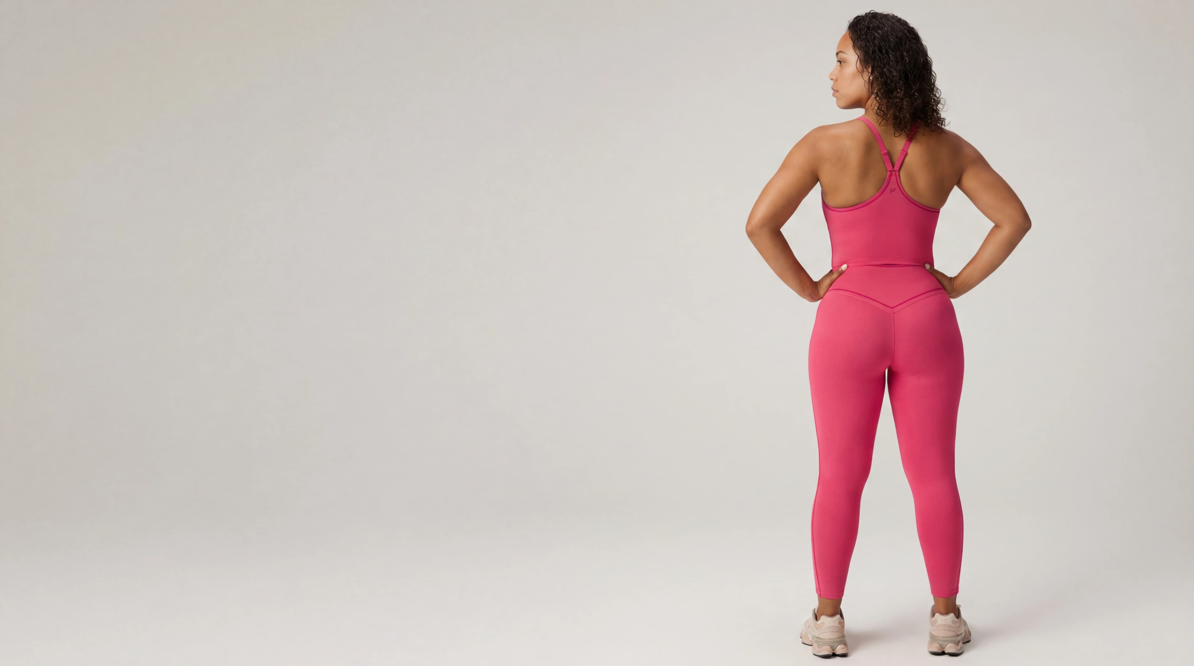 Woman in pink sports bra and leggings set back view — AI activewear product photography for social